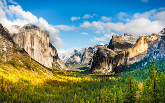Tunnel View overlooking Yosemite Valley with Bridalveil Falls in the distance.