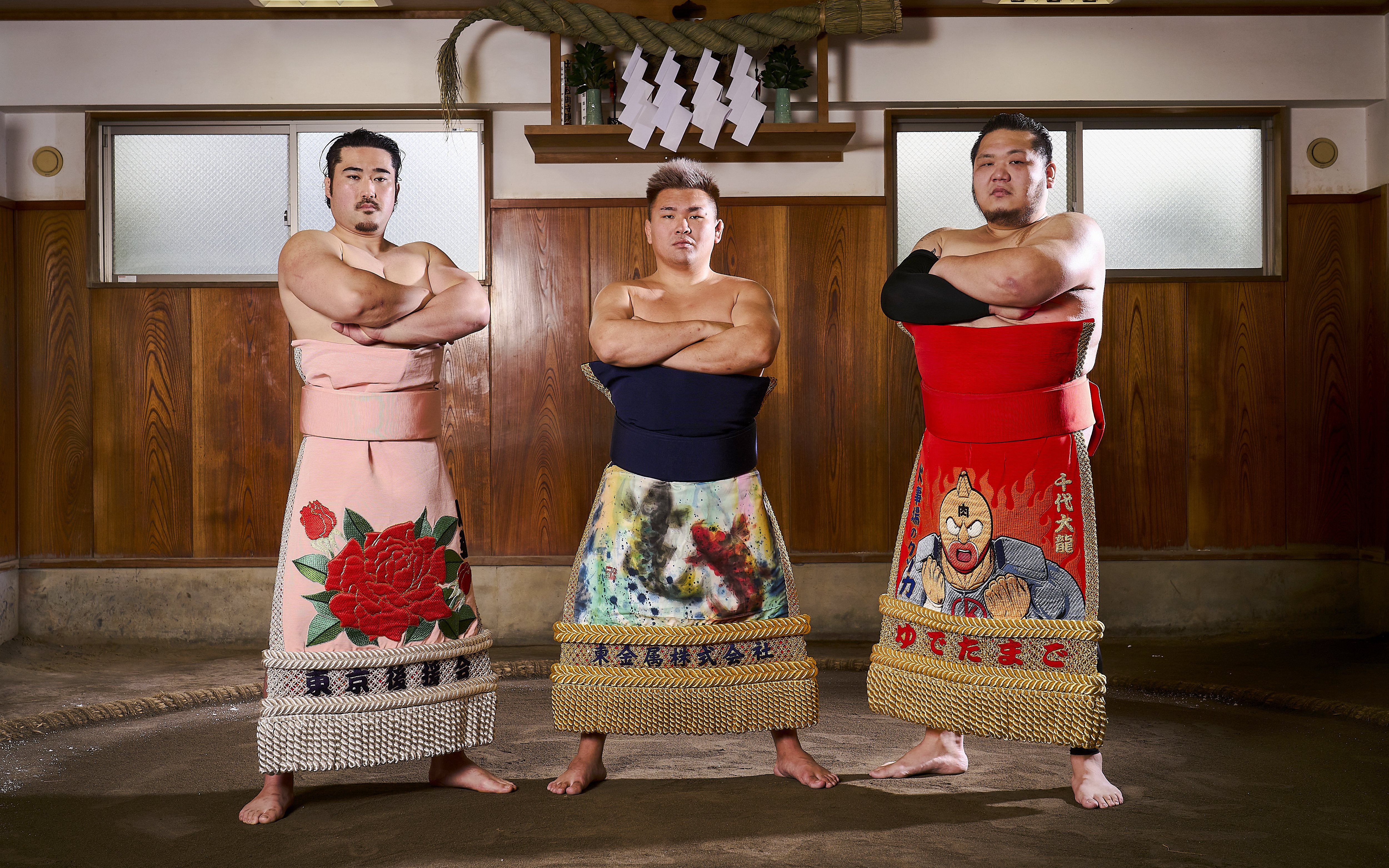 Sumo wrestlers in traditional attire at a Koto City sumo show.