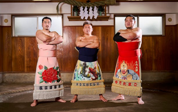 Sumo wrestlers in traditional attire at a Koto City sumo show.
