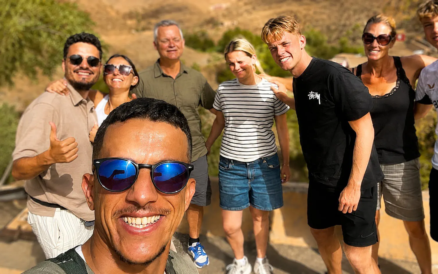 Tour group enjoying a day trip in Marrakech, Morocco with scenic background.