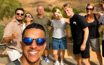 Tour group enjoying a day trip in Marrakech, Morocco with scenic background.