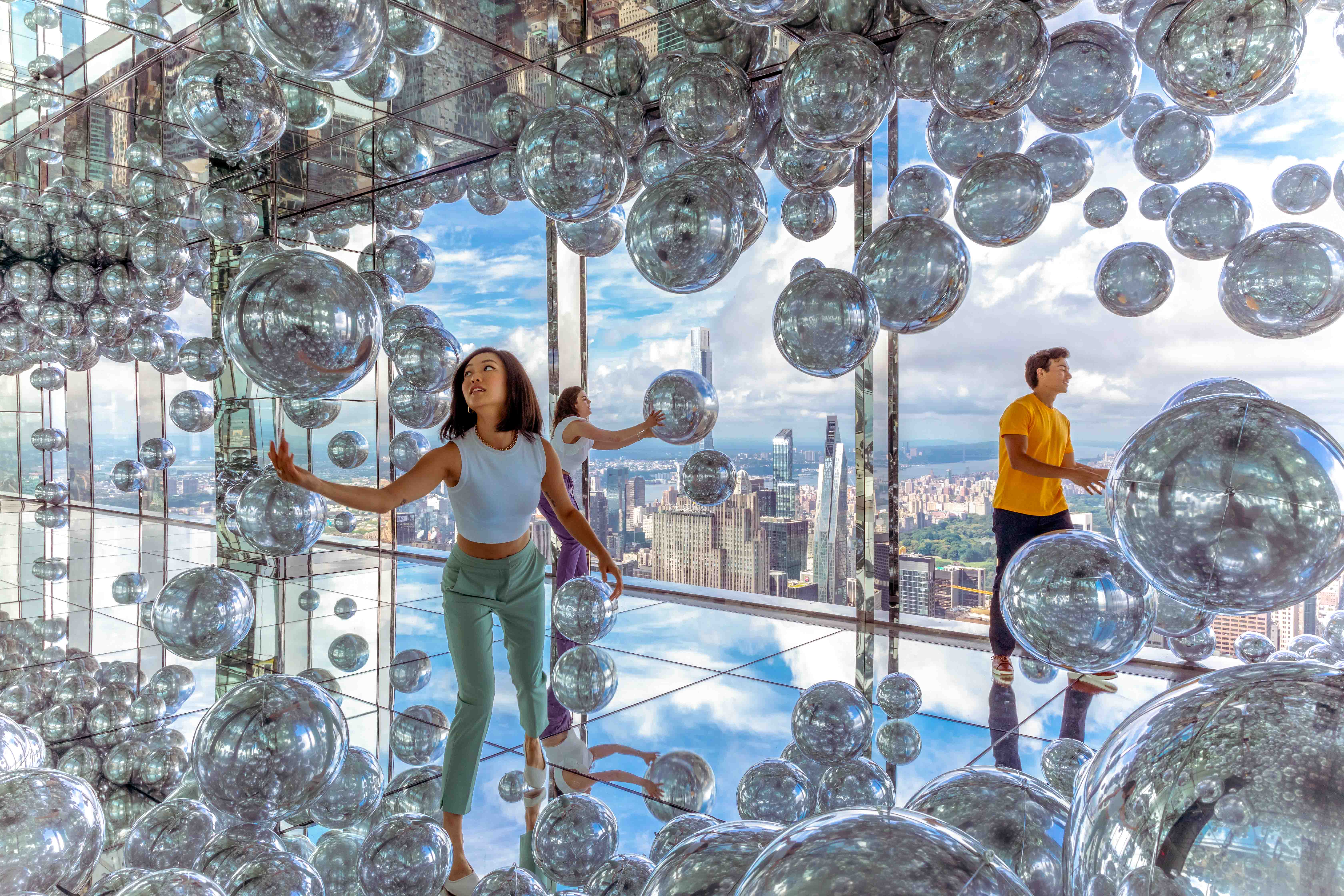 Visitors enjoying panoramic views from Summit One Vanderbilt observation deck in New York City.
