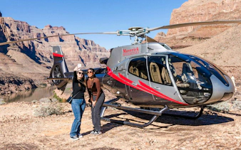 Helicopter landed at Grand Canyon West with two people taking a selfie.
