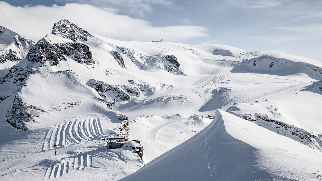 Matterhorn Glacier Paradise snowy landscape with ski tracks and mountain peaks.