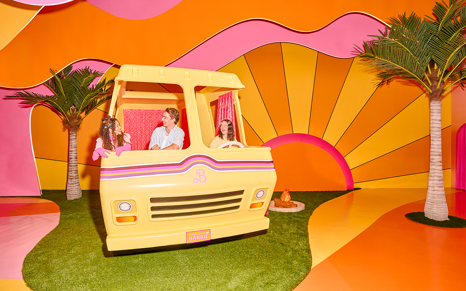 Guests enjoying Barbie The Dream Experience in a colorful camper setup, Amsterdam.