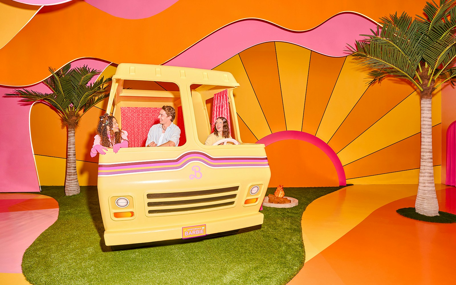 Guests enjoying Barbie The Dream Experience in a colorful camper setup, Amsterdam.