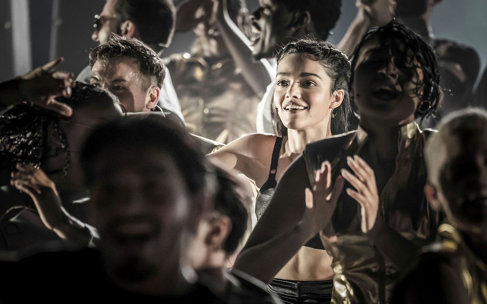 Performers on stage during the Evita Musical, engaging with the audience.