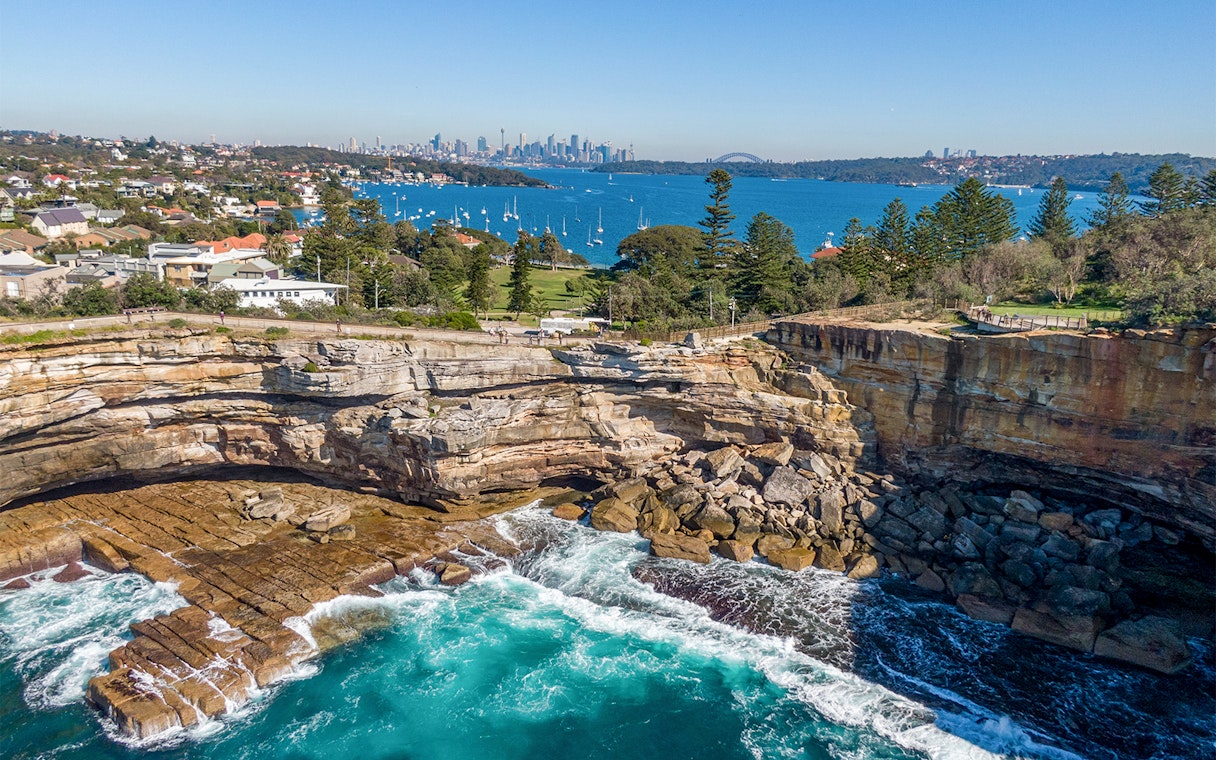 Cliffs and ocean view at Watsons Bay with Sydney skyline in the background.