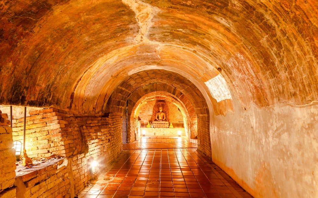 Buddha statue in a brick tunnel at Wat Umong Temple, Chiang Mai, Thailand.