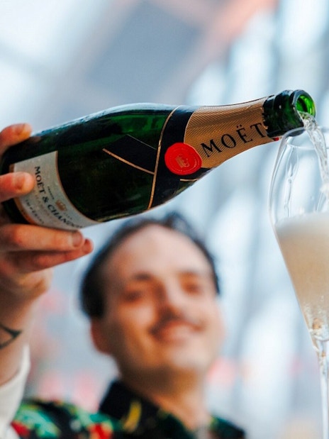 Pouring champagne at Sky Garden Music Night, London.