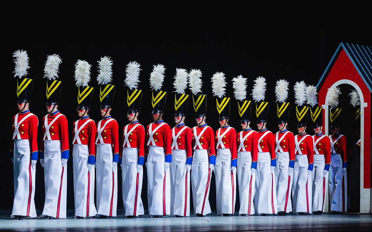 Radio City Rockettes in toy soldier costumes during Christmas Spectacular performance.