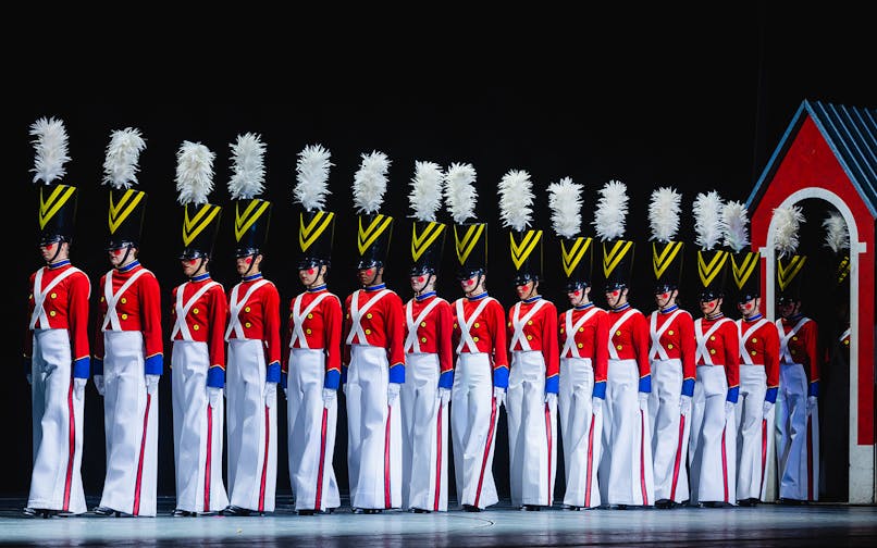 Radio City Rockettes in toy soldier costumes during Christmas Spectacular performance.