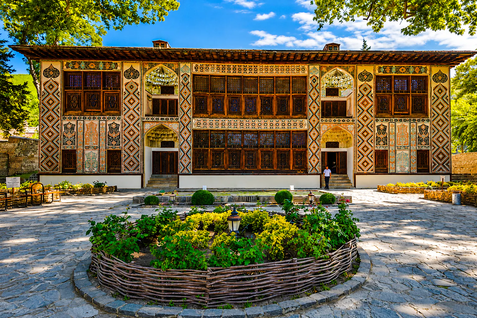 Khan's Palace in Sheki with intricate facade and garden, part of Baku to Sheki tour.