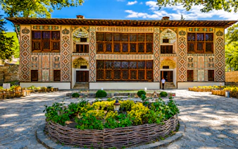 Khan's Palace in Sheki with intricate facade and garden, part of Baku to Sheki tour.