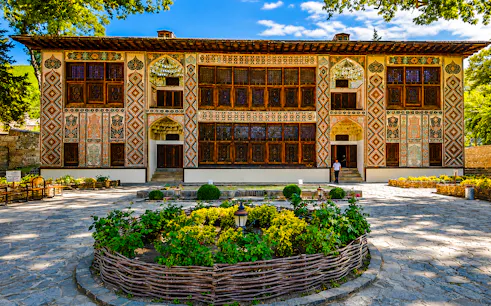Khan's Palace in Sheki with intricate facade and garden, part of Baku to Sheki tour.