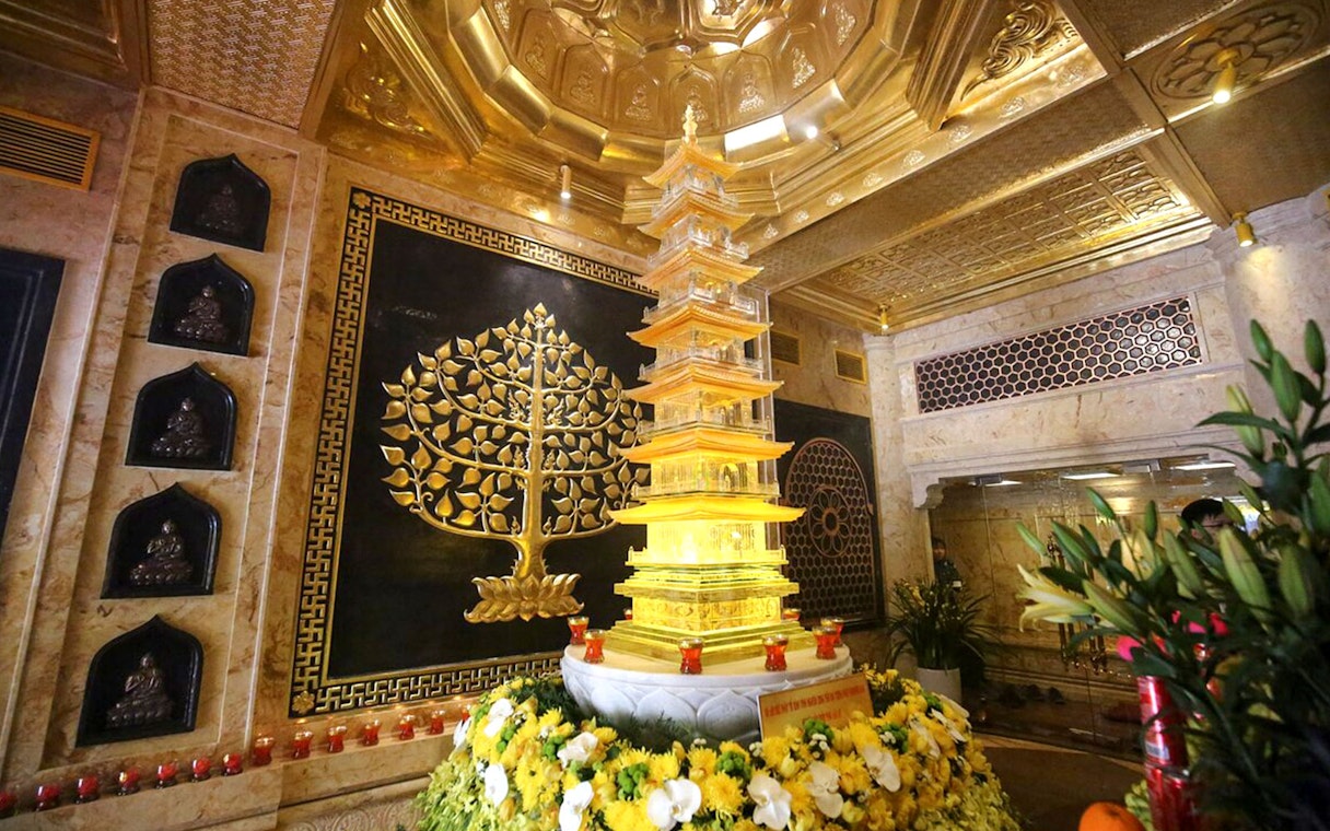 Golden pagoda and intricate wall art at Sun World Fansipan Legend, Vietnam.