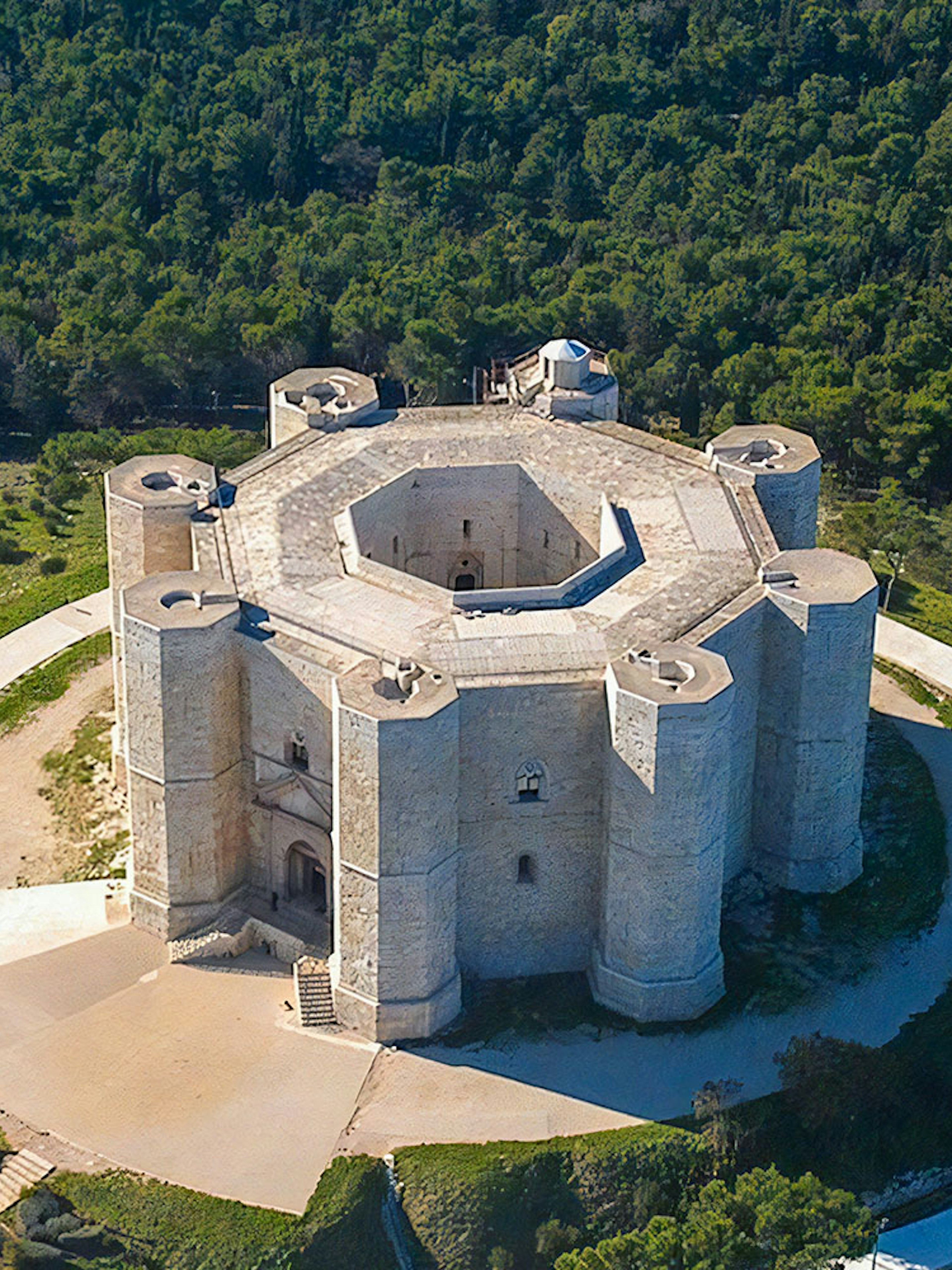 Aerial view of Castel del Monte surrounded by greenery in Andria, Puglia.