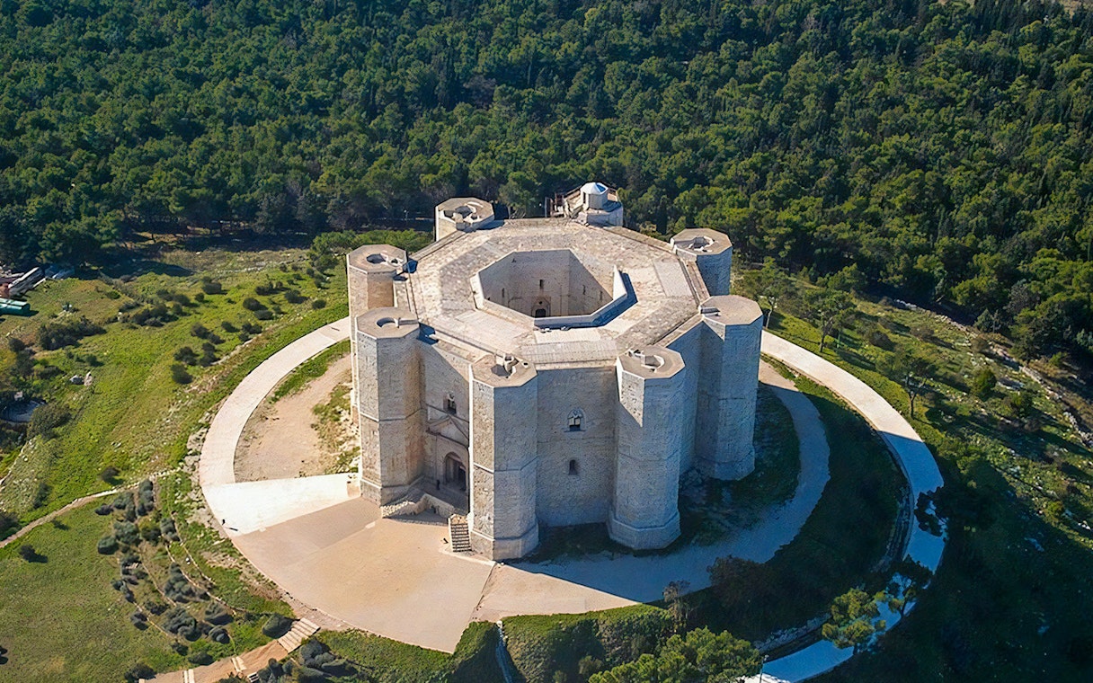 Aerial view of Castel del Monte surrounded by greenery in Andria, Puglia.