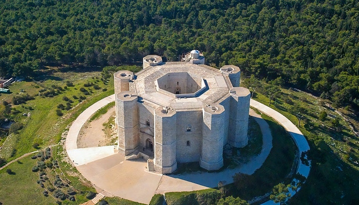 Aerial view of Castel del Monte, Andria, Puglia, showcasing the octagonal fortress and surrounding landscape.