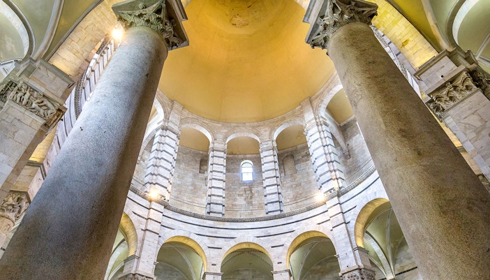 Tourists exploring Pisa Monumental Complex with Baptistery & Cathedral, using audio guide tickets for an immersive experience