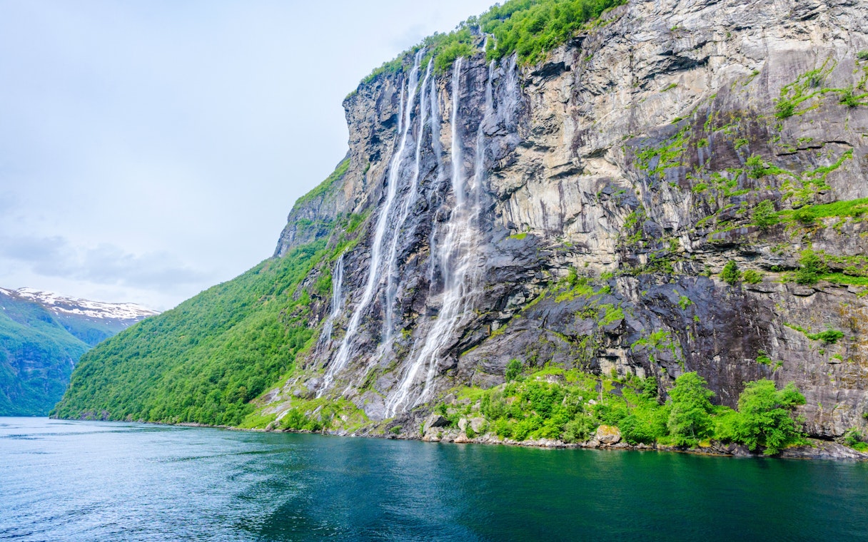 Seven Sisters waterfall cascading down a cliff in Geiranger, Norway.