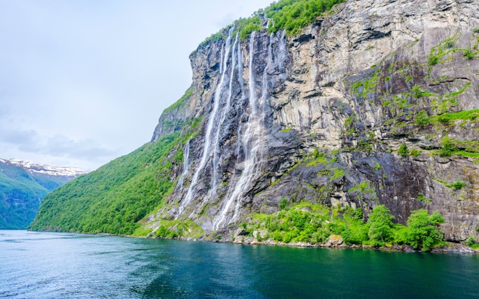 Seven Sisters waterfall cascading down a cliff in Geiranger, Norway.