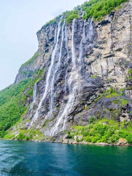 Seven Sisters waterfall cascading down a cliff in Geiranger, Norway.
