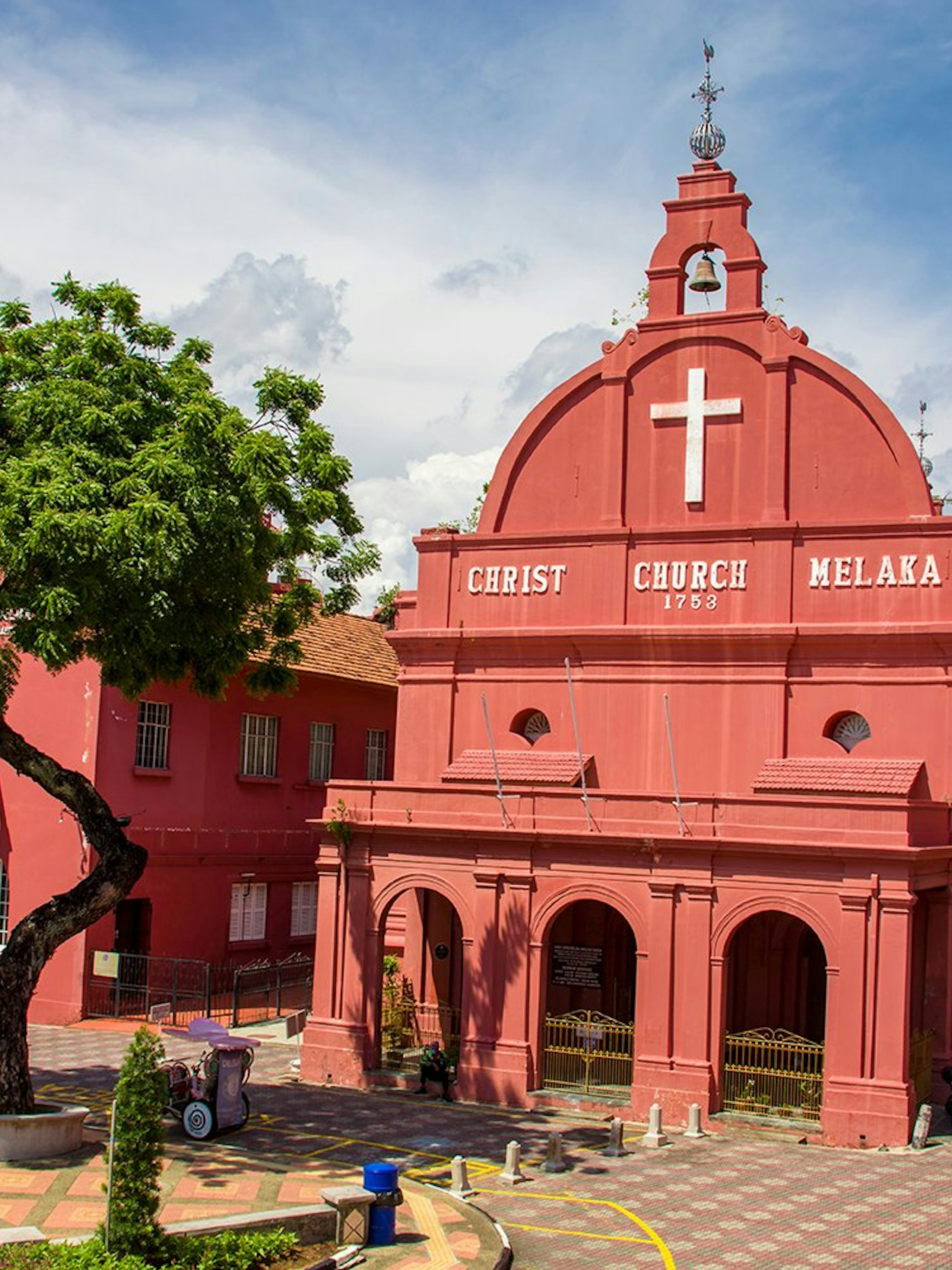 Christ Church in Malacca City, an 18th-century Anglican church with red facade and bell tower.