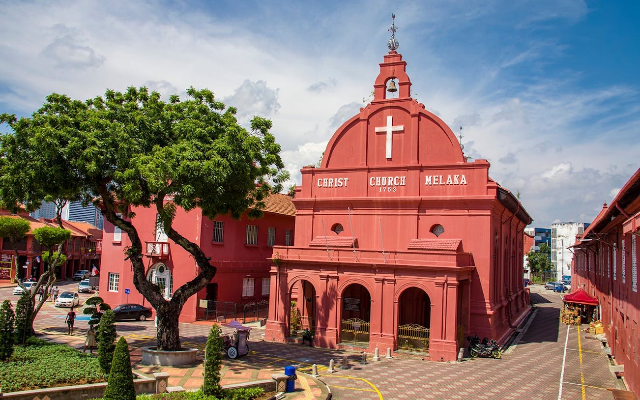 Christ Church in Malacca City, an 18th-century Anglican church with red facade and bell tower.