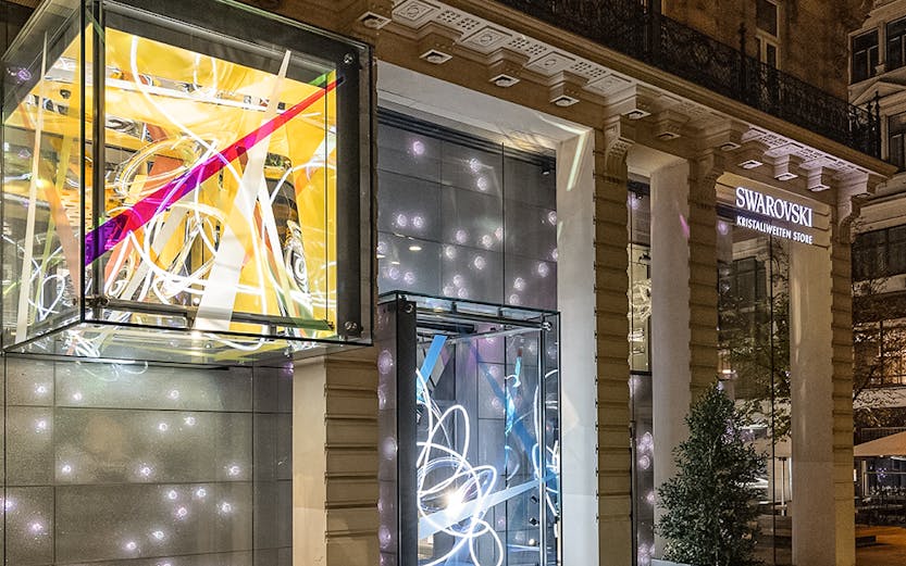 Swarovski House entrance with illuminated displays in Vienna.