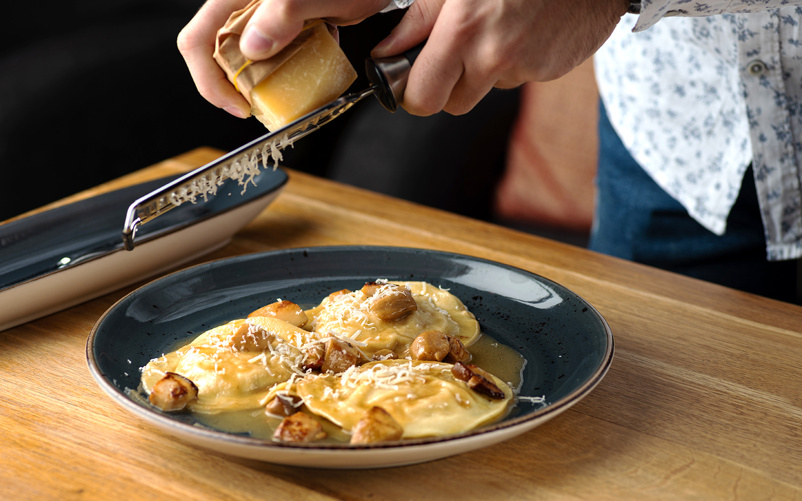 Outdoor dining setup with tables and chairs overlooking Valletta's skyline, Malta.