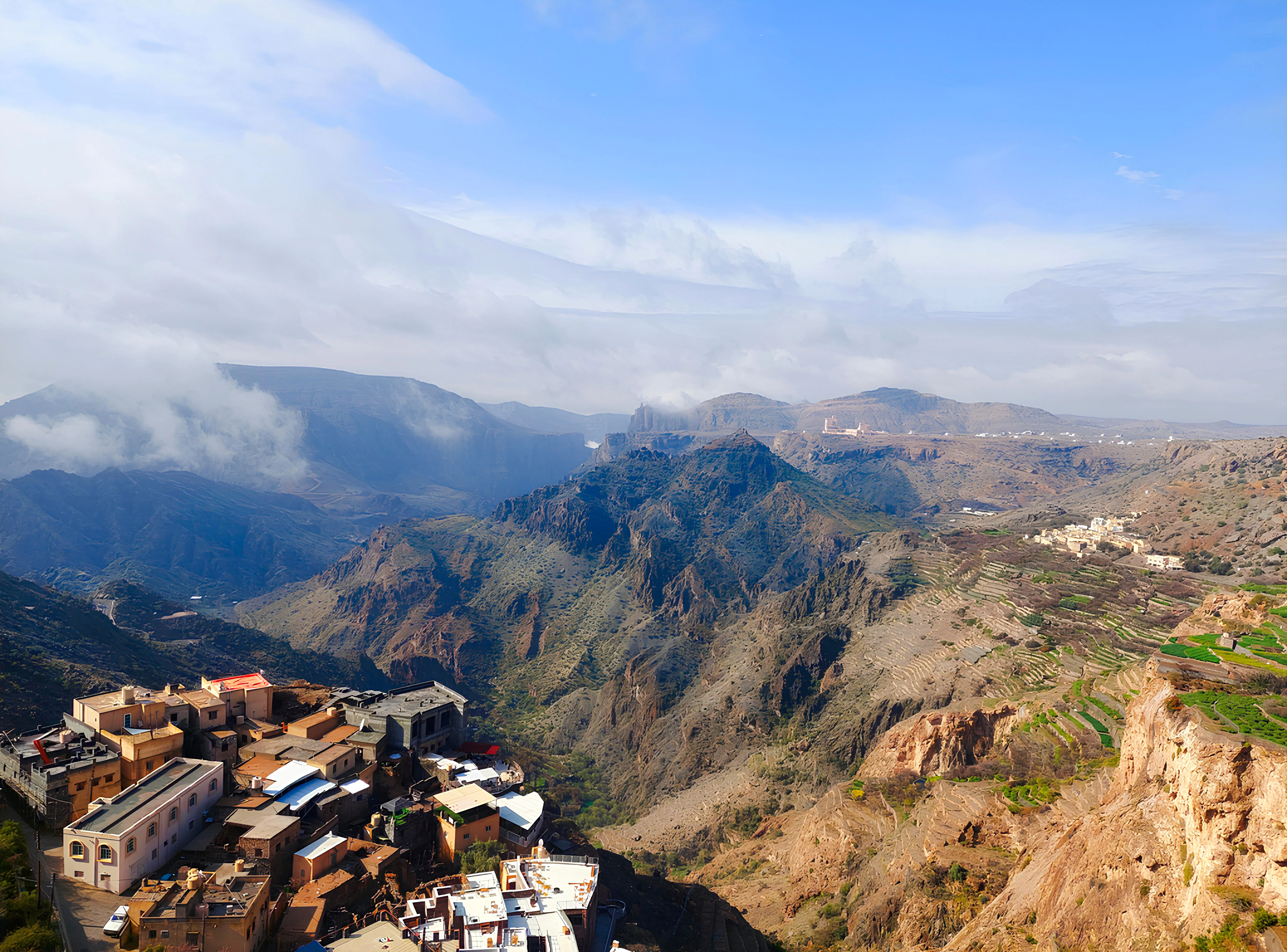 Nizwa and Jebel Akhdar mountains with terraced fields and village, Oman day trip.