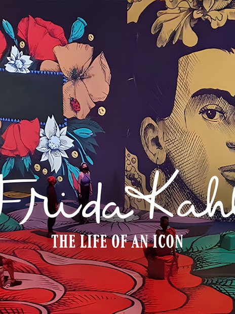 Frida Kahlo exhibit with floral art and visitors at Art Science Museum's Future World.