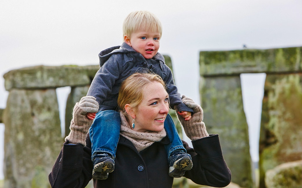 Mother and child visiting Stonehenge, England.