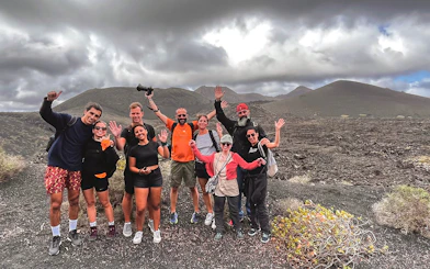 Group of hikers at Timanfaya Volcano Natural Park during a guided trek.