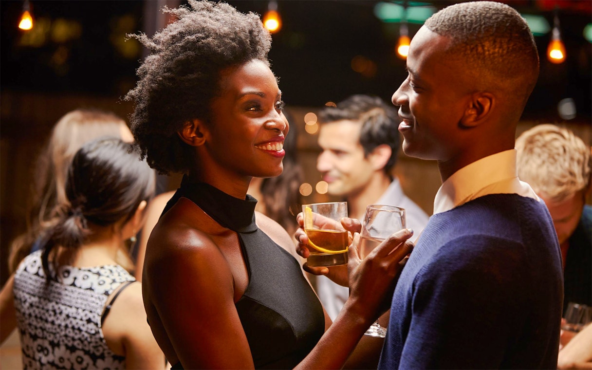 Guests enjoying drinks on a Miami party cruise.