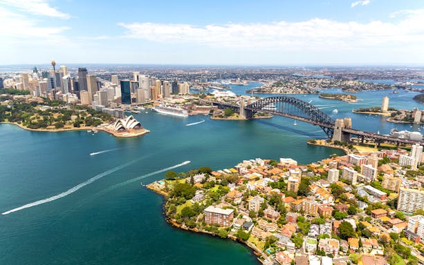 Aerial view of Sydney Harbour with Opera House and Harbour Bridge.