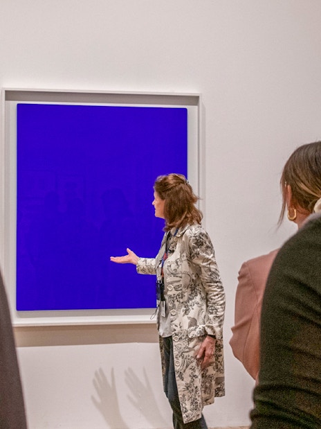 Guide explaining artwork during a tour inside Tate Modern.