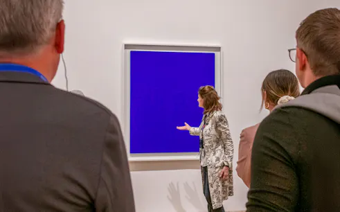 Guide explaining artwork during a tour inside Tate Modern.