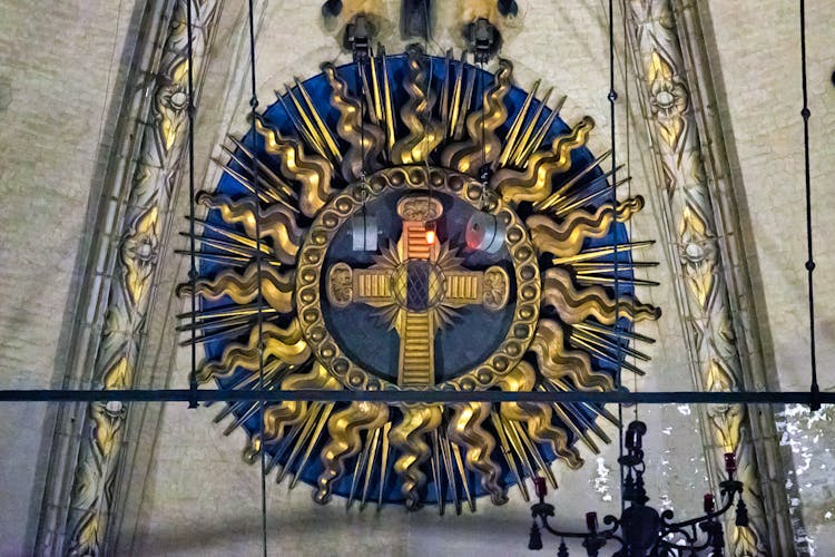 Duomo Milan Cathedral relic of passion, ornate cross with golden rays.