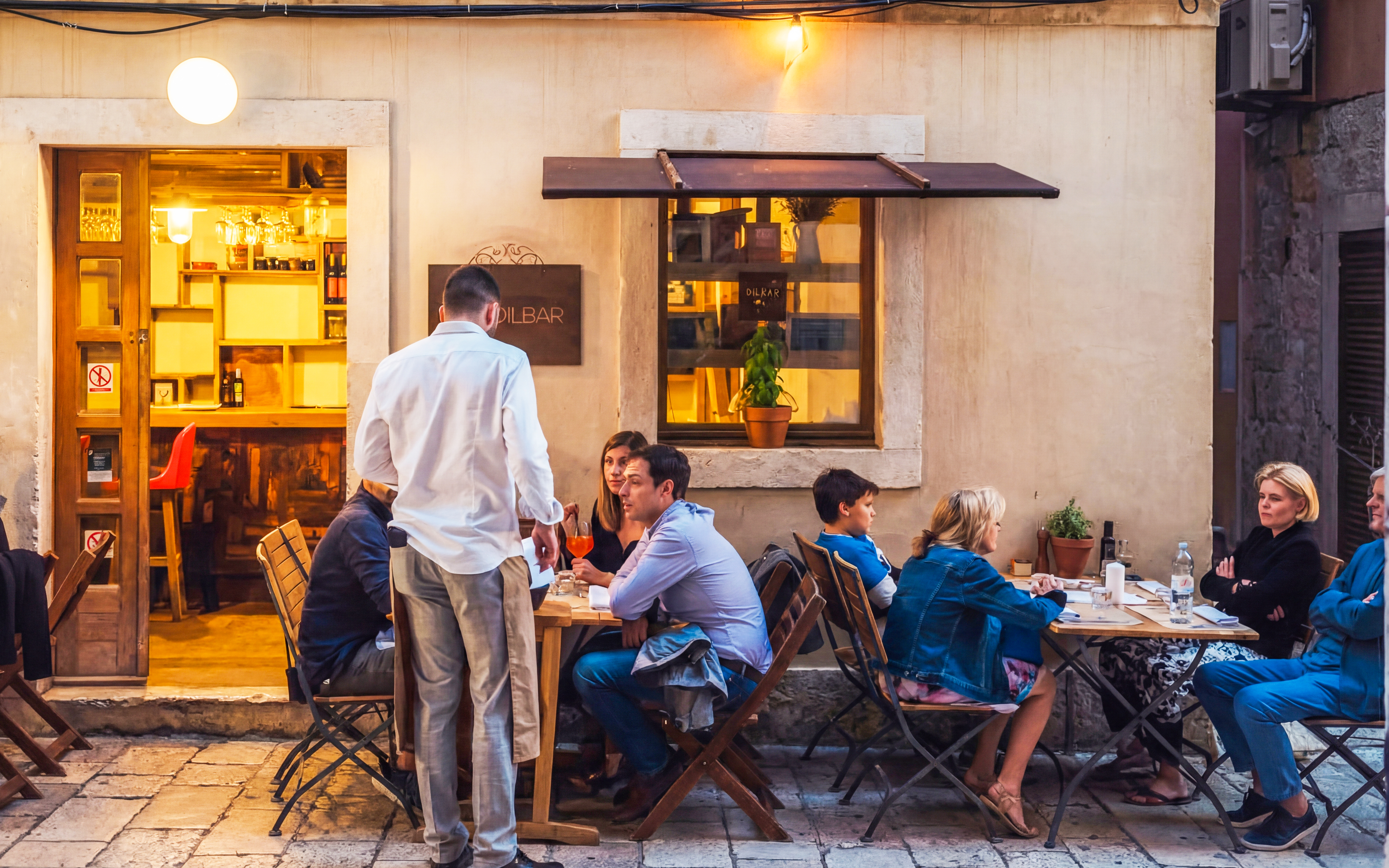 Wine tasting group at an outdoor cafe in Diocletian’s Palace, Split, Croatia.