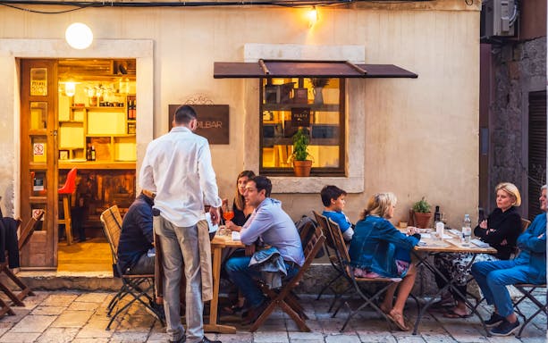 Wine tasting group at an outdoor cafe in Diocletian’s Palace, Split, Croatia.