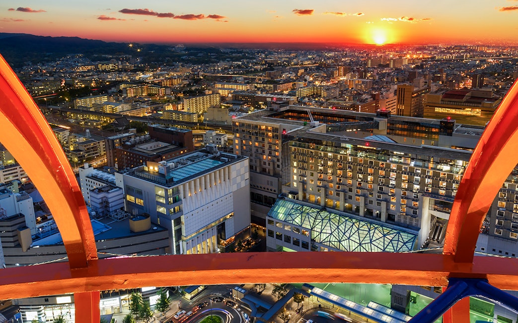 Kyoto cityscape from Kyoto Tower at sunset, highlighting urban architecture.