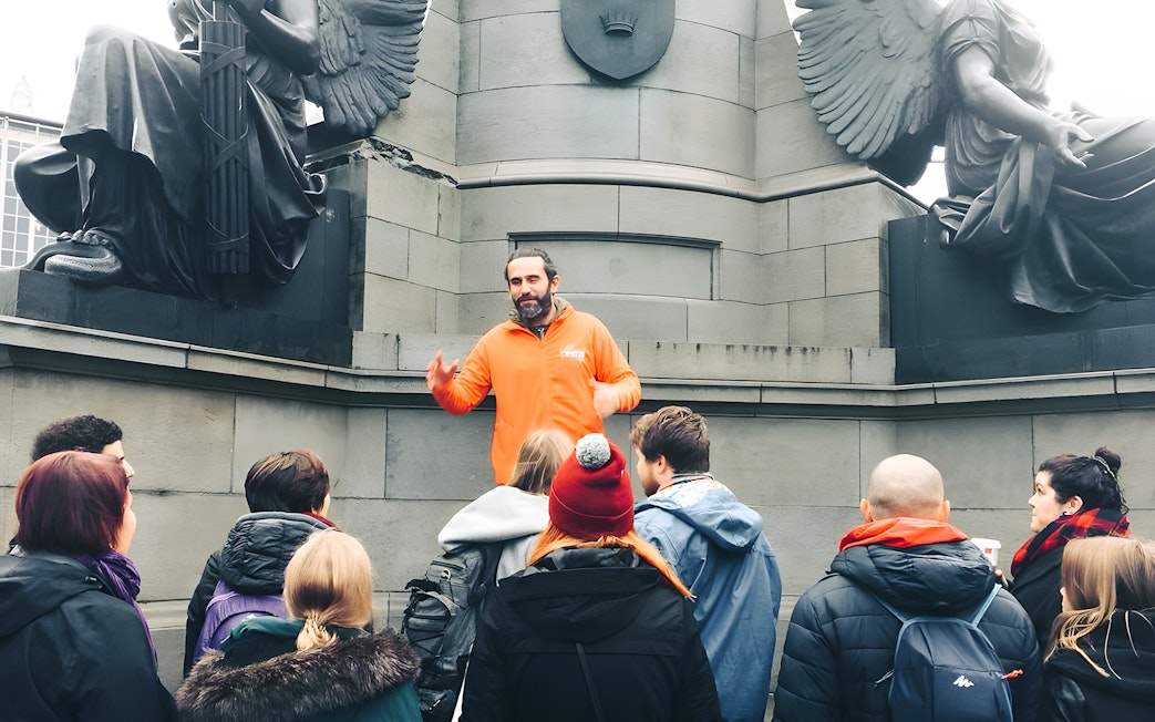 Tour guide leading a group at a monument in Dublin.