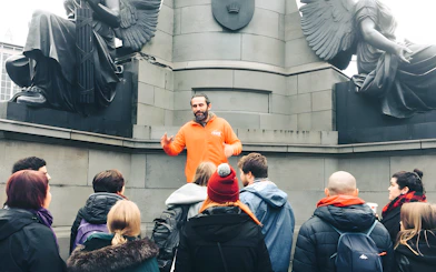 Tour guide leading a group at a monument in Dublin.