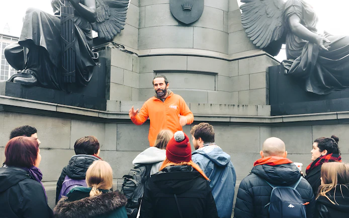 Tour guide leading a group at a monument in Dublin.