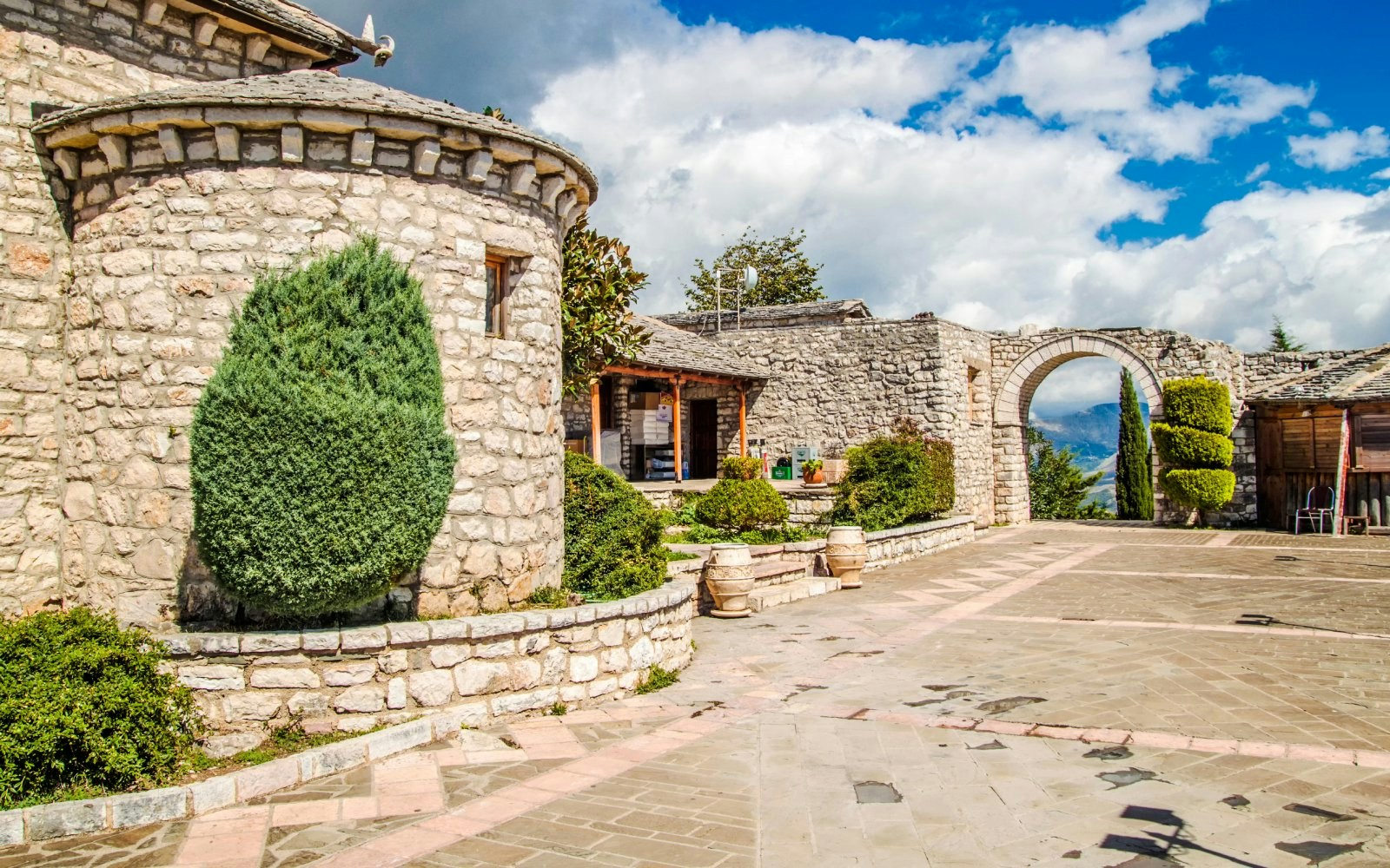 Stone courtyard and archway at Lekursi Castle in Saranda, Albania.