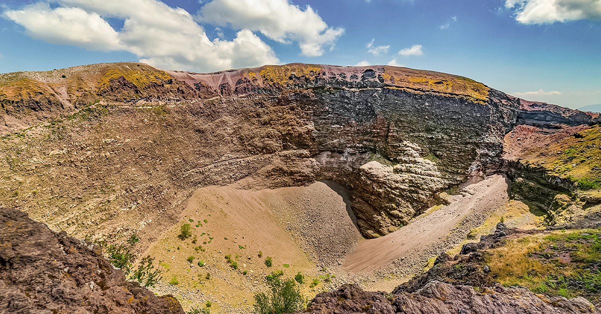 Mount Vesuvius crater with rocky terrain under a clear blue sky.