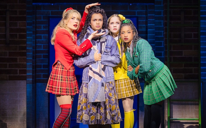 Cast members performing in "Heathers: The Musical" on stage.