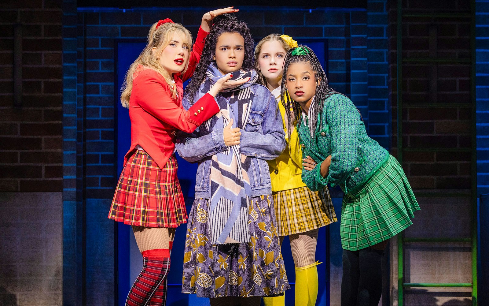 Cast members performing in "Heathers: The Musical" on stage.